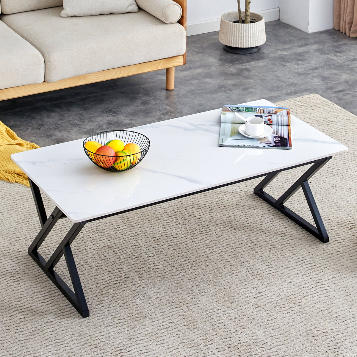 A coffee table made of rock slab material, with a smooth and natural surface that complements the modern design of the black metal legs, making it suitable for living rooms of all sizes.47*23.6